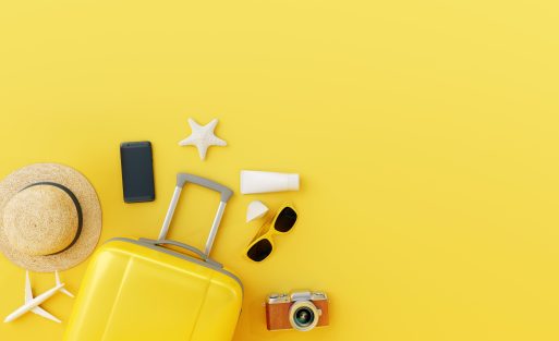 Flat,Lay,Yellow,Suitcase,With,Traveler,Accessories,On,Yellow,Background.